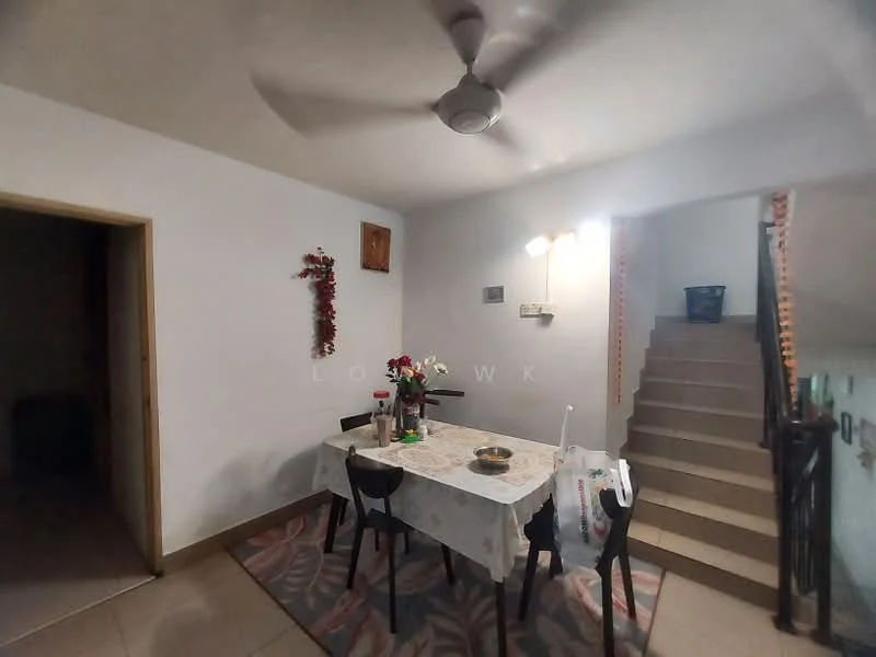 Dining features: dining table with tablecloth, 4 dining chairs, ceiling fan, wall-mounted light fixtures, decorative wall hanging, staircase in background, tiled flooring, white painted walls. Room features: doorway leading to another room, staircase.