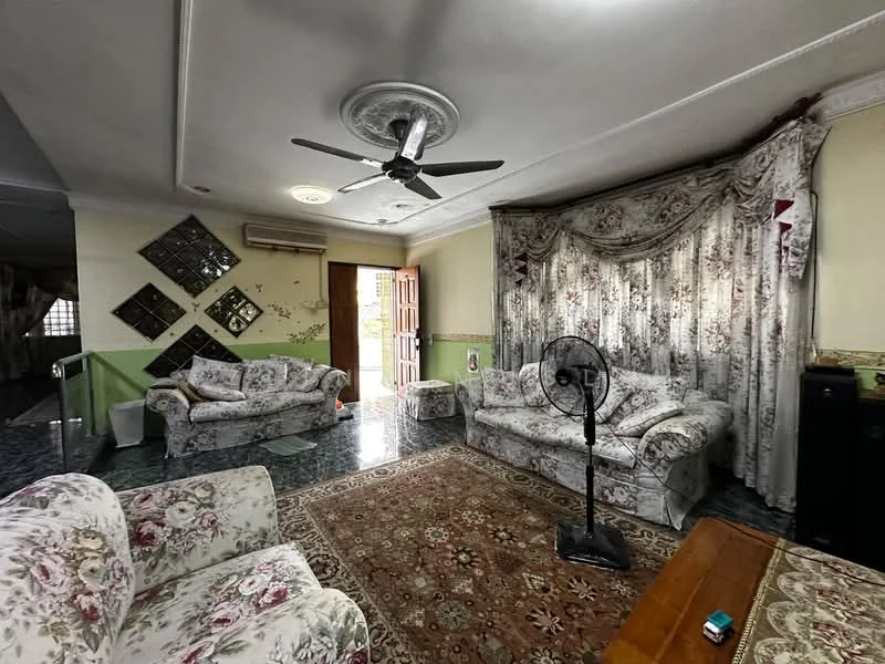 Living features: 3-seater fabric sofa with floral pattern, 2-seater fabric sofa with floral pattern, coffee table, area rug with intricate pattern, ceiling fan with light, wall-mounted air conditioning unit, curtains with floral pattern, decorative wall mirrors, green accent wall, tiled flooring, wooden door leading outside; style: traditional; view: garden.