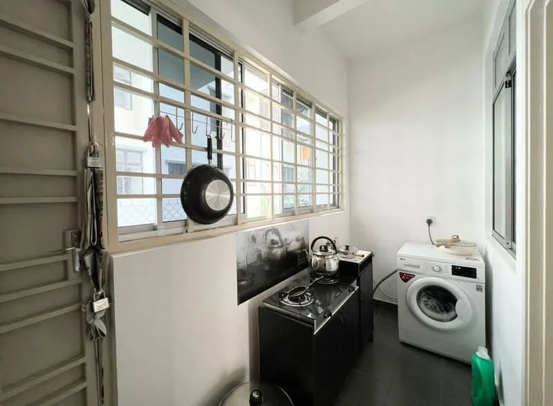 Laundry features: white walls, grey tiled flooring, single-bowl stainless-steel sink, chrome faucet, built-in gas stove, black countertop, washing machine, window with metal grille, pantry shelf, kettle, cooking pot, floor-mounted storage bin.