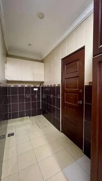 Laundry features: cream painted walls, dark brown tiled walls, light beige floor tiles, wooden door, built-in cabinetry, countertop above cabinetry, single-basin sink, wall-mounted faucet, light fixture on ceiling.