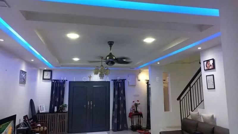 Living features: white painted walls, polished tile flooring, tray ceiling with recessed lighting, 5-blade ceiling fan with light, LED strip lighting, dark grey curtains, framed artwork on walls, built-in wardrobe, sofa in beige, coffee table, TV console, staircase in background; style: modern.