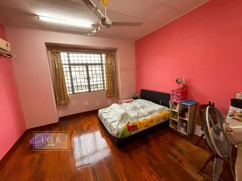 Bedroom features: pink painted walls, wooden flooring, ceiling fan, floor-to-ceiling window, curtains, double bed with colorful bedding, nightstand, wall-mounted shelf, freestanding fan.