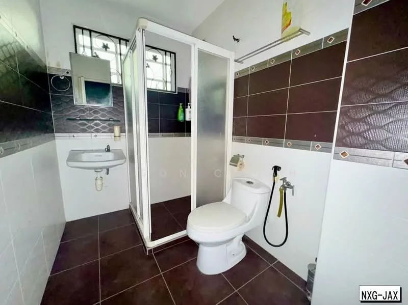 Bathroom features: white ceramic toilet, single-sink vanity with wall-mounted mirror, glass shower enclosure, chrome wall-mounted faucet, brown and white tiled walls, dark ceramic floor tiles, shower head, towel rack, soap dispenser, window with metal grille; style: modern.