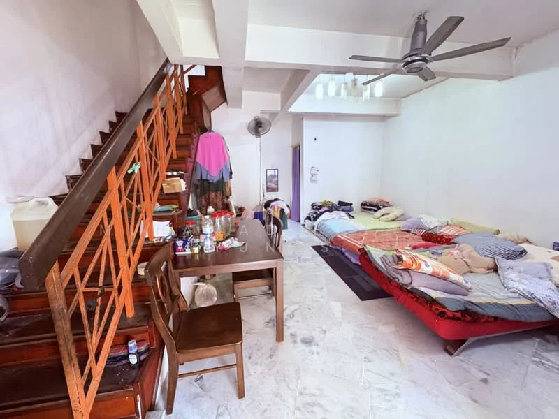 Living features: marble tile flooring, white painted walls, 5-blade ceiling fan, wooden staircase, dining table with chairs, multiple bedding arrangements, wall-mounted fan, decorative items on table.