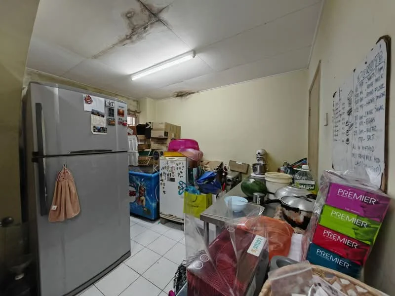 Kitchen features: stainless-steel fridge, white fridge, white tiled flooring, white walls, fluorescent ceiling light, metal countertop, multiple kitchen appliances, boxes and clutter on countertops.