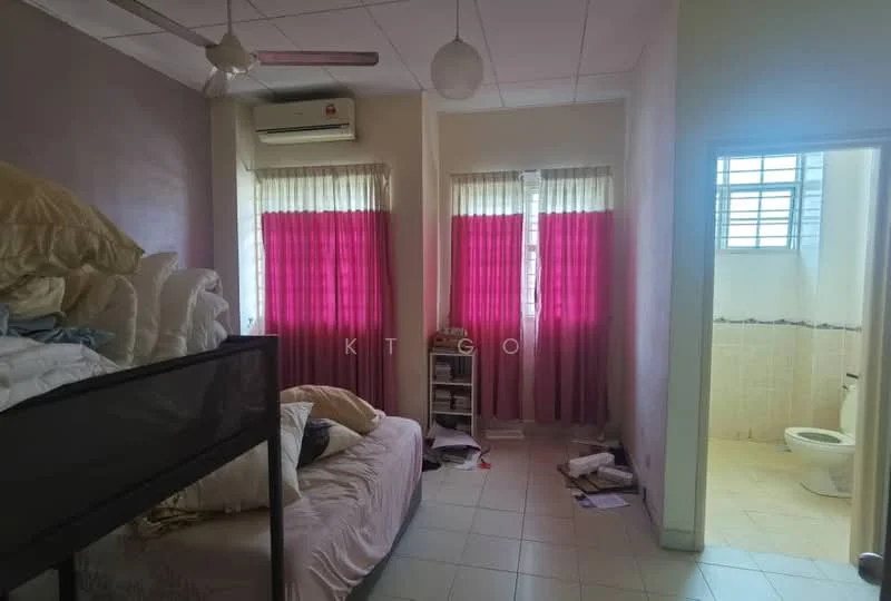 Bedroom features: 2 windows with sheer curtains, pink curtains, 1 wall-mounted split AC, ceiling fan, twin beds with bedding, nightstand, stack of pillows, scattered papers on the floor, tile flooring, light-colored walls, built-in wardrobe, doorway leading to bathroom. Bathroom features: toilet, sink, tile flooring, wall tiles, window, light fixture.
