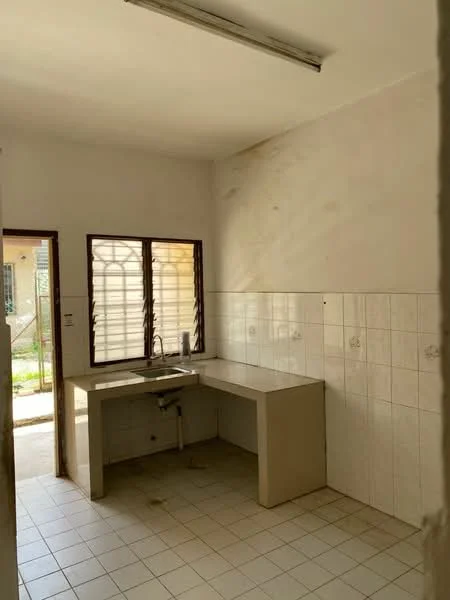 Kitchen features: white tiled walls, grey countertop, single-bowl sink, window with metal grille, floor tiles, light fixture on ceiling, empty space for appliances, no cabinetry visible.