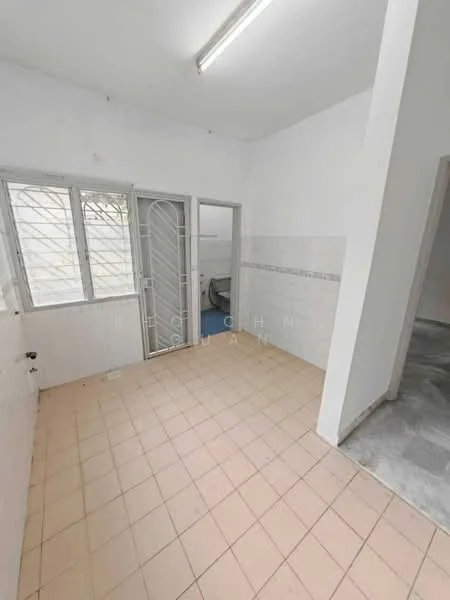 Room features: white painted walls, tile flooring in beige, window with metal grille, door with metal grille, light fixture on ceiling, corner of room with grey flooring, white tiled backsplash, visible plumbing fixtures.