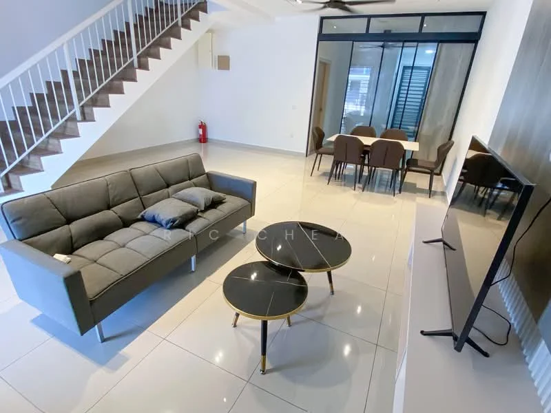 Living features: grey fabric sofa, 2 coffee tables with black tops and gold legs, wall-mounted TV, white walls, white tiled flooring, ceiling fan, large glass sliding door, dining area visible in background, staircase with white railing, fire extinguisher on wall; style: modern.