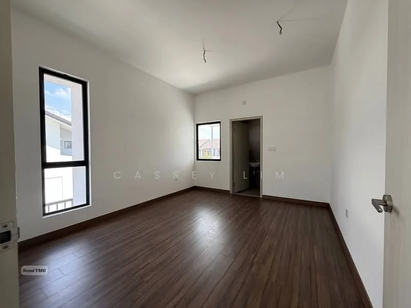 Room features: white painted walls, wooden flooring, two windows, door leading to another room, high ceiling, no visible ceiling fixtures.
