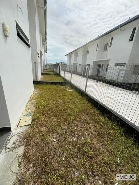 Exterior type: linked terrace house; features: fenced yard, concrete pathway, overgrown grass, white painted facade, two-storey structure, surrounding residential area; style: modern.