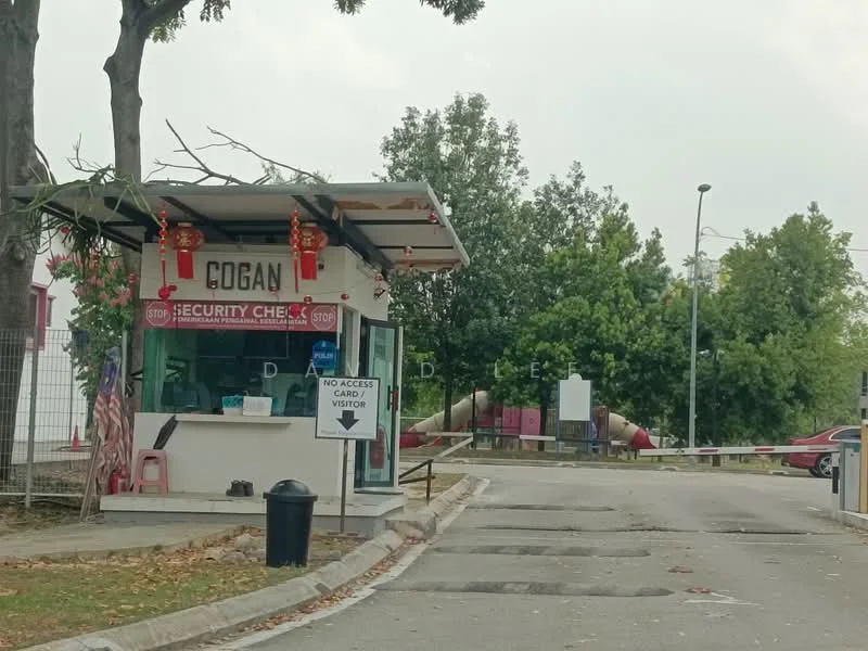 Exterior type: guard house; features: security checkpoint, stop sign, signage with 'Cogan', landscaped greenery, paved road, visible playground equipment in background, traffic barrier, visitor access sign; style: modern.