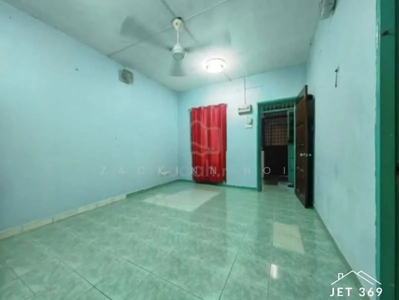 Room features: light green painted walls, grey ceramic tile flooring, ceiling fan, red curtains, wooden door, air conditioning unit, window with security grille, corner wall-mounted light fixture.