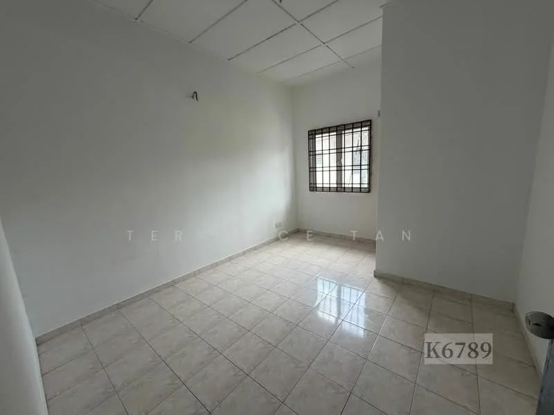 Room features: white painted walls, tile flooring, window with grid pattern, ceiling with panels, corner space, neutral color scheme.