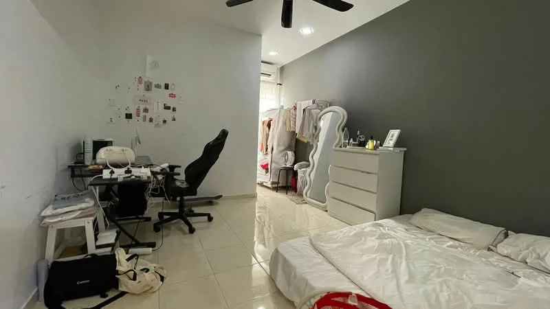 Bedroom features: white painted walls, grey accent wall, glossy tile flooring, queen-size bed with white bedding, white dresser, black office chair, desk with computer setup, floor fan, clothing rack, decorative mirror, wall-mounted decor, natural light from window; style: modern.