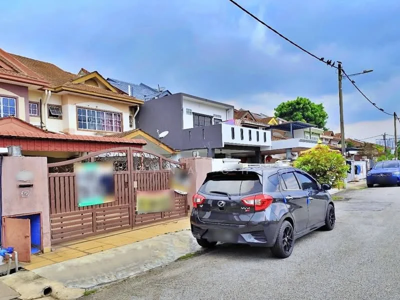 Exterior type: linked terrace house; features: two-storey house, red tiled roof, cream painted facade, grey accent wall, front porch with tiled flooring, manicured garden, fenced front yard, driveway with car, street view, power lines visible, adjacent houses in background; style: modern.