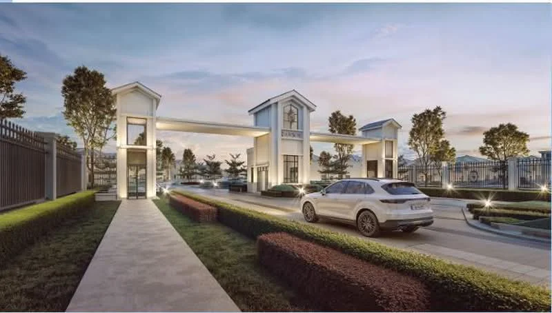 Exterior type: main entrance gate; features: gated entrance, two-storey gatehouse, manicured hedges, paved driveway, landscaped garden, security lighting, surrounding trees, modern architectural design; style: modern.