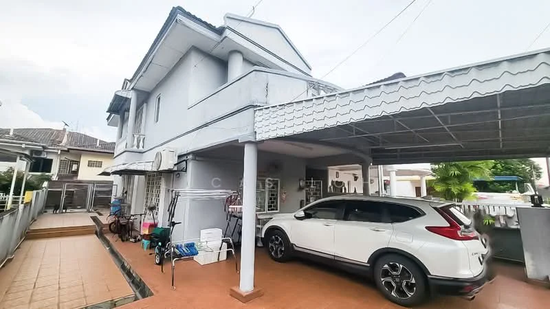 Exterior type: semi-detached house; features: grey painted facade, flat roof, car porch with awning, driveway with interlocking pavers, manicured lawn, outdoor seating area, visible air conditioning unit, laundry area with clothesline, surrounded by residential neighborhood; style: modern.