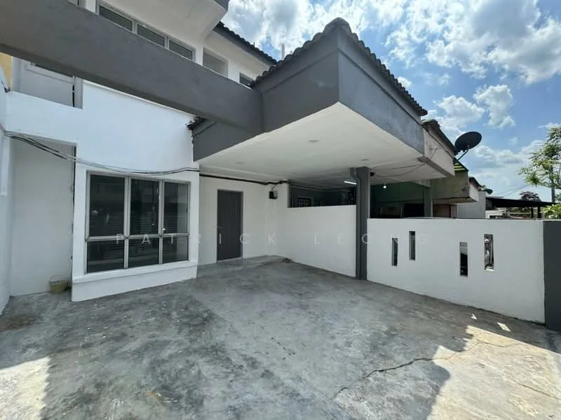 Exterior type: linked terrace house; features: flat roof, white painted facade, concrete driveway, exposed concrete flooring, grey accent wall, single main entrance door, windows with grills, satellite dish on roof, surrounded by greenery; style: modern.