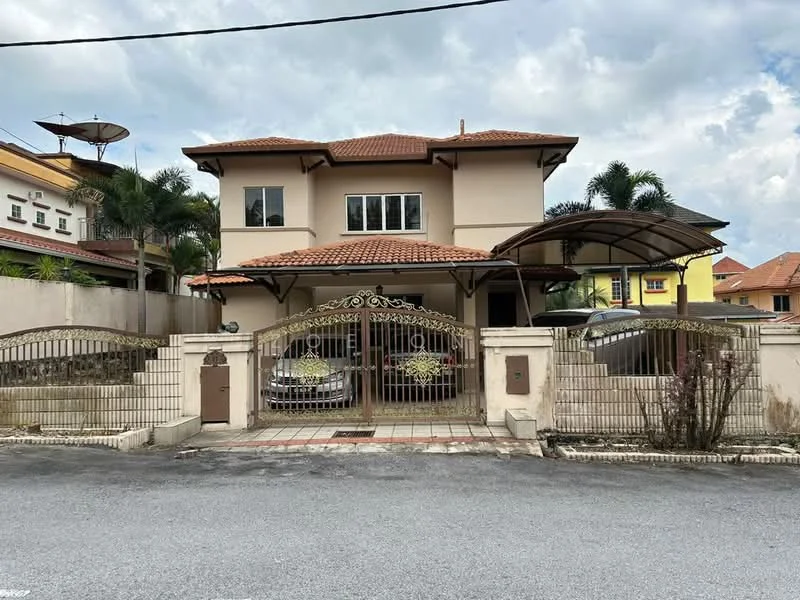 Exterior type: detached bungalow; features: two-storey building, red tiled roof, cream painted facade, gated entrance, ornate metal gate, car porch with awning, driveway with interlocking pavers, surrounded by palm trees, satellite dish on roof, manicured landscaping, front garden area; style: modern.