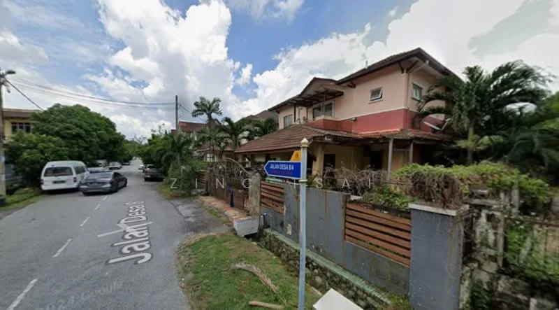 Exterior type: semi-detached house; features: two-storey building, cream painted facade, red tiled roof, front porch with railing, manicured lawn, palm trees, fenced yard, street view with road sign, adjacent driveway, surrounded by greenery; style: modern.
