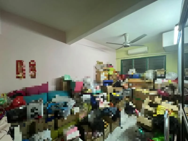 Room features: light pink painted walls, ceiling fan, wall-mounted split AC, carpeted flooring, cluttered with boxes and items.