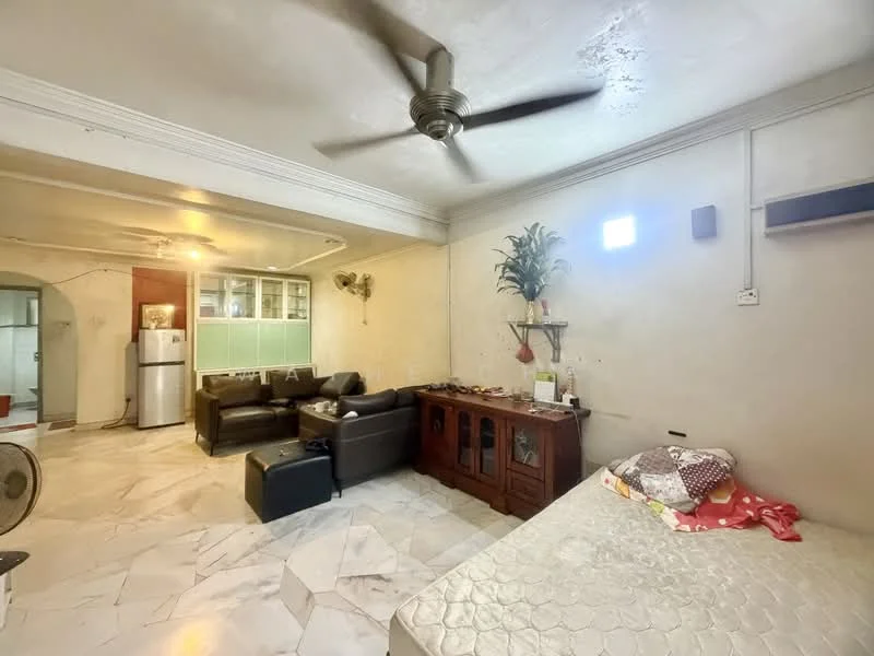 Living features: 5-blade ceiling fan, wall-mounted air conditioning unit, marble flooring, cream painted walls, sofa in dark leather, wooden cabinet, small table, decorative plant, window with natural light, refrigerator visible in background.