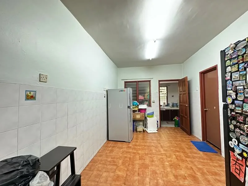 Kitchen features: white painted walls, ceramic tile flooring, refrigerator, wooden cabinets, countertop, sink, window, door, light fixture, storage boxes, blue mat.