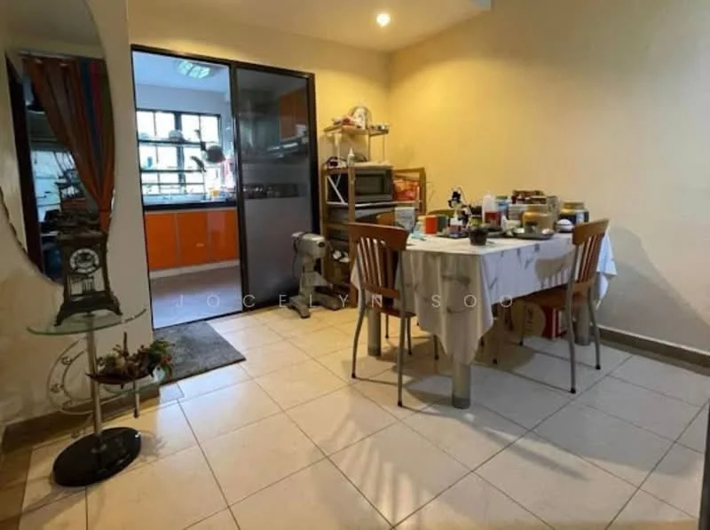 Dining features: tile flooring, cream painted walls, dining table with white tablecloth, four wooden dining chairs, kitchen area visible in background, glass sliding door, kitchen appliances visible, decorative plant on stand, area rug at entrance, overhead lighting.