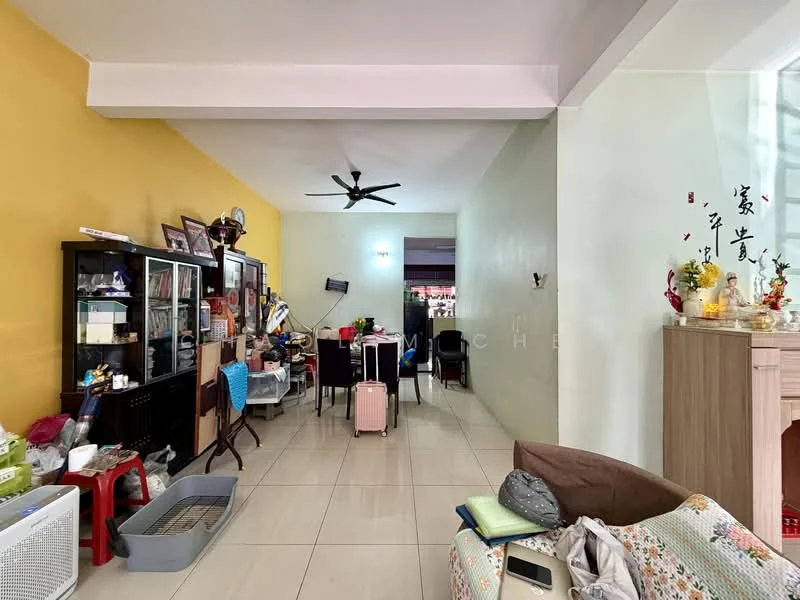 Living features: yellow accent wall, light green painted walls, white ceiling, 5-blade ceiling fan, tiled flooring, wooden shelving unit, sofa with decorative cushions, luggage on the floor, dining table with chairs, decorative wall art, open layout to adjacent room; style: modern.