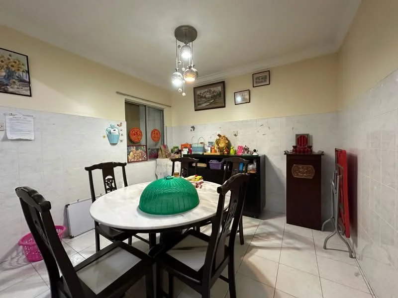 Dining features: round dining table with white tabletop, 4 wooden dining chairs with dark finish, white tiled flooring, cream painted walls, wall-mounted artwork, window with sheer curtains, decorative wall clock, kitchen counter with cabinets, small countertop appliances, green decorative basket on table, pink storage basket, recessed ceiling lights; style: traditional.