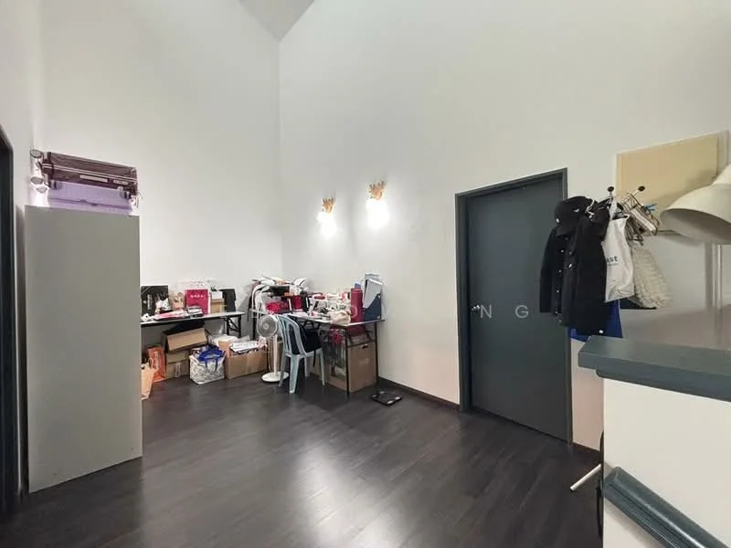 Room features: white painted walls, dark wood laminate flooring, high ceiling, two wall-mounted sconces, desk with sewing machine, plastic chair, storage boxes, door with grey finish, coat rack, light fixture; style: modern.