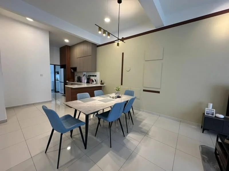 Dining features: 6-seater dining table, blue upholstered dining chairs, white marble tabletop, pendant lighting, wall-mounted TV, cream painted walls, grey accent wall, tile flooring, open kitchen view, decorative wall panels; style: modern. Kitchen features: wood cabinetry, built-in appliances, countertop, open layout; style: modern.