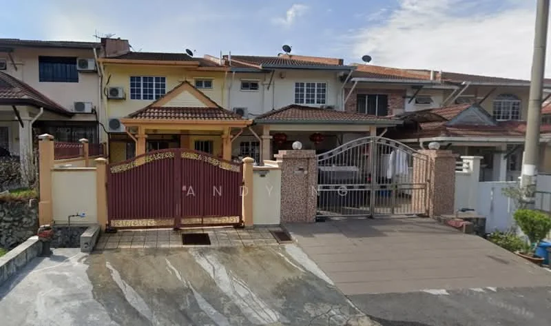 Exterior type: linked terrace house; features: red and cream painted facade, gated entrance with decorative metal gate, paved driveway, manicured lawn, multiple air conditioning units visible, two-storey structure, front porch area, decorative stone cladding on entrance, surrounded by residential neighborhood; style: modern.