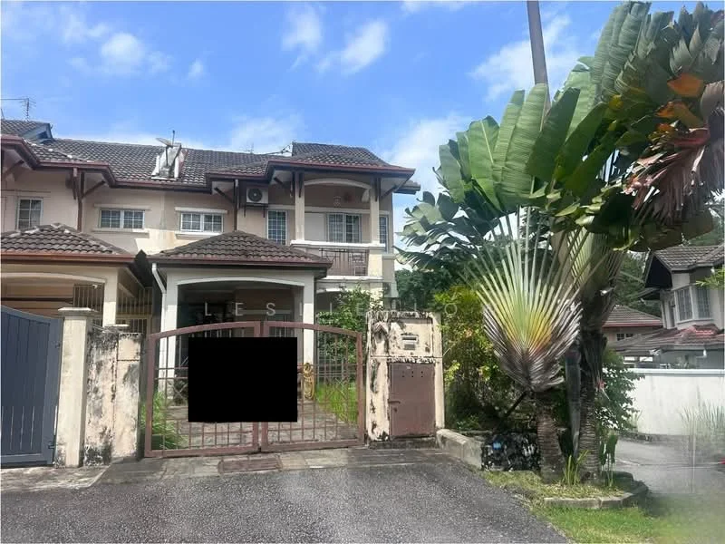 Exterior type: semi-detached house; features: two-storey structure, brown painted facade, gated entrance, manicured garden, palm trees, tropical landscaping, sloped roof with tiles, driveway with interlocking pavers, front porch, visible air conditioning unit; style: traditional.