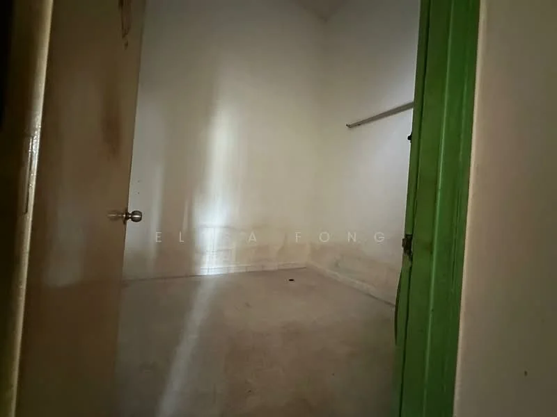 Room features: plain white walls, concrete flooring, single door, green door frame, shelf mounted on wall, no visible windows, high ceiling, minimal decor; style: minimalist.