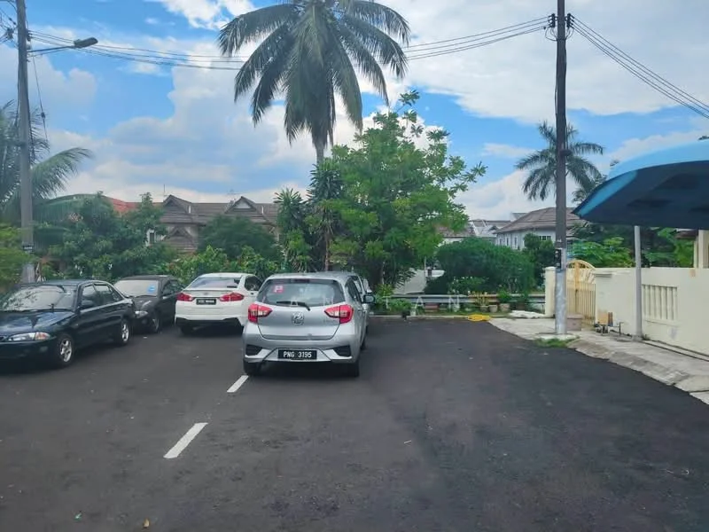 Exterior features: paved road, parking lot, palm trees, green landscaping, residential buildings in background, overhead power lines, cloudy sky.