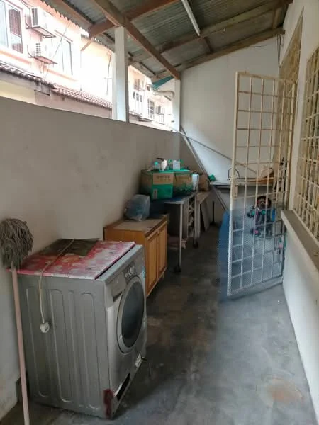 Laundry features: washing machine, wooden cabinet, concrete flooring, metal roof, open space, utility sink, storage boxes, mop, grid door.