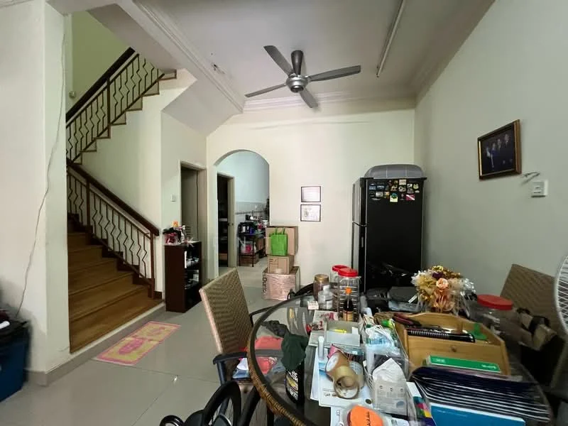 Living features: 5-blade ceiling fan, round dining table, upholstered dining chairs, black refrigerator, wooden staircase, cream painted walls, tile flooring, decorative wall frame, open shelving, various household items on table. Room features: cream painted walls, tile flooring.