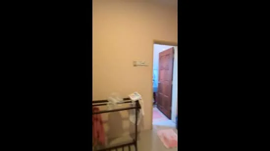 Room features: light beige painted walls, tile flooring, wooden door, door frame, window frame, visible door to another room, crib, pink rug.
