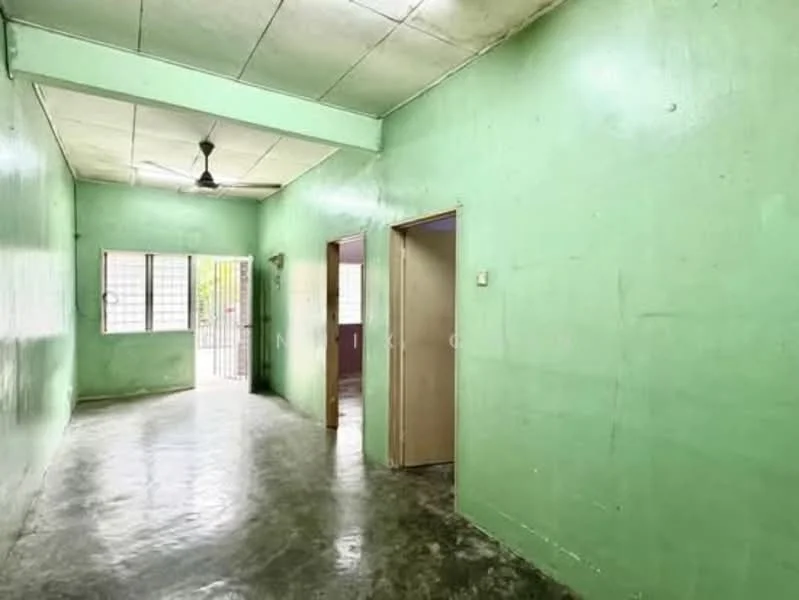 Room features: green painted walls, concrete flooring, ceiling fan, window with metal grille, doorway leading outside, doorway to adjacent room.
