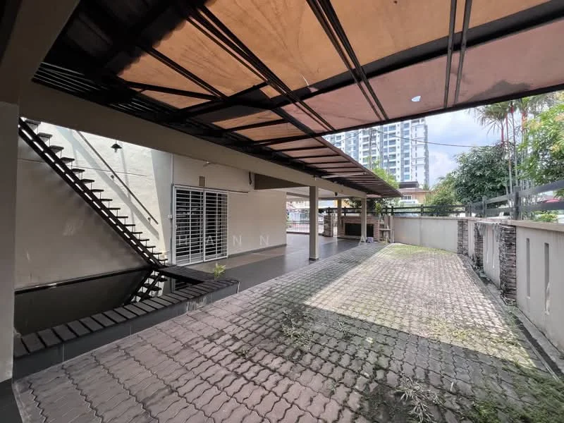 Exterior features: covered car porch, paved driveway, staircase leading to upper level, exposed concrete walls, manicured landscaping, surrounding greenery, fence, adjacent building visible; style: modern.