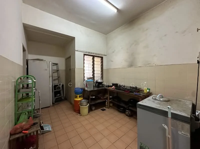 Kitchen features: white painted walls, tile flooring, single-bowl stainless-steel sink, chrome pull-down faucet, built-in gas stove, exhaust hood, freestanding refrigerator, countertop with storage underneath, open shelving, plastic storage containers, cleaning cart, various cooking utensils.