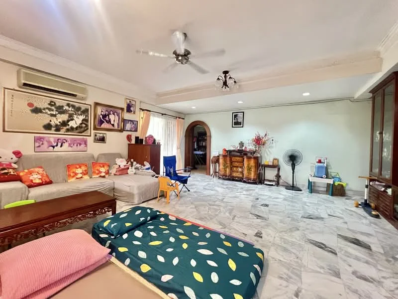 Living features: marble tile flooring, white painted walls, ceiling fan, wall-mounted air conditioning unit, sofa with colorful cushions, wooden sideboard, decorative wall art, large window with sheer curtains, folding chair, floor fan, area rug with geometric pattern; style: contemporary.