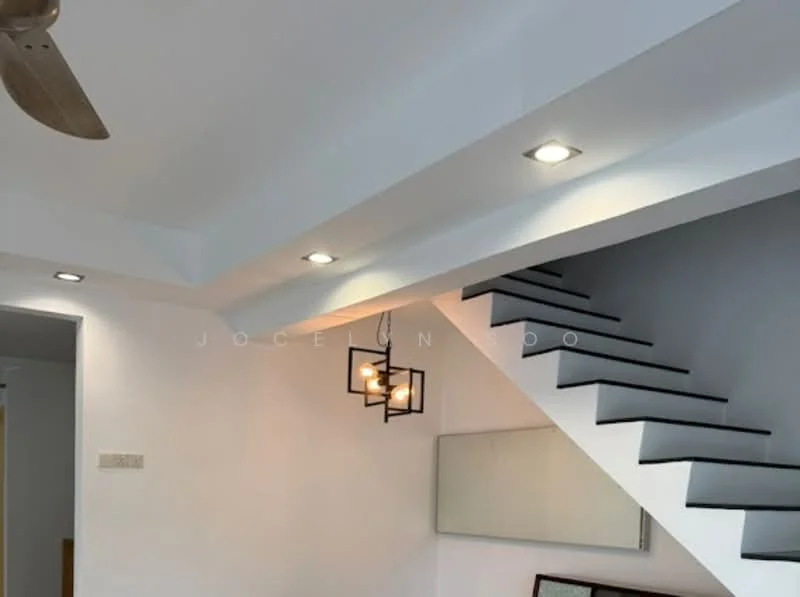 Room features: white painted walls, exposed beams, recessed downlights, pendant light, staircase with black steps, mirror on wall, ceiling fan; style: modern.