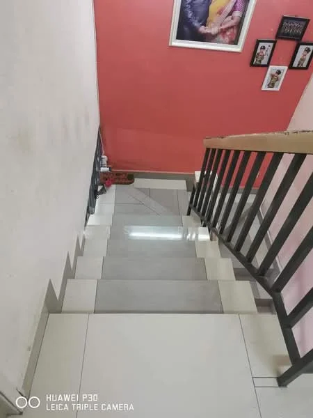 Room features: white painted walls, pink accent wall, ceramic tile flooring, wooden handrail, staircase with risers, framed artwork on wall, photo frames on wall, light fixture on ceiling; style: modern; view: staircase.