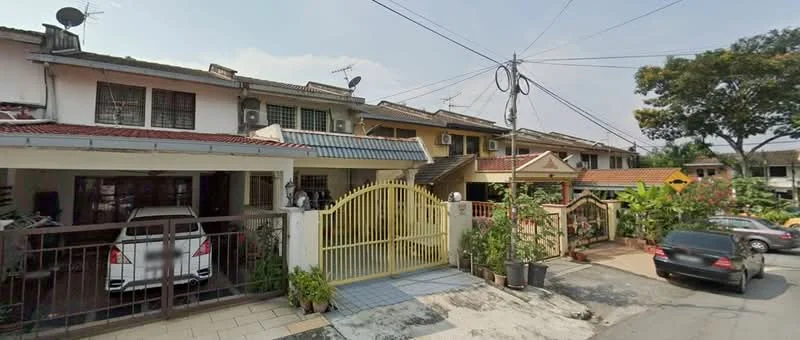 Exterior type: linked terrace house; features: yellow painted facade, flat roof, two-storey building, manicured lawn, paved walkway, car porch with awning, multiple satellite dishes, decorative gate, surrounded by greenery, driveway with interlocking pavers; style: modern.