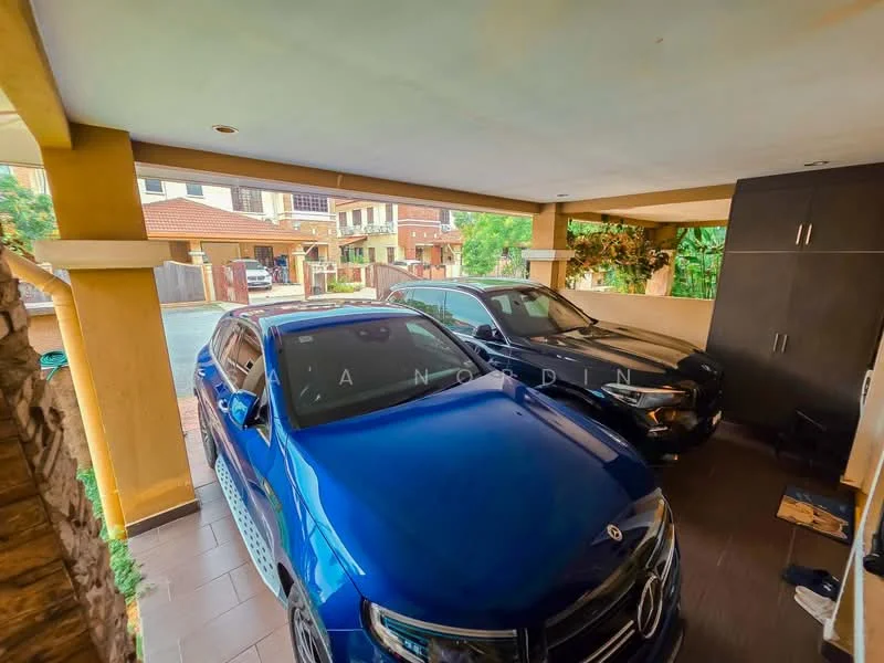 Exterior type: car porch; features: two parked cars, tiled flooring, yellow painted walls, overhead ceiling lights, stone feature wall, greenery visible in background, built-in storage cabinet, open space, covered area; style: modern.