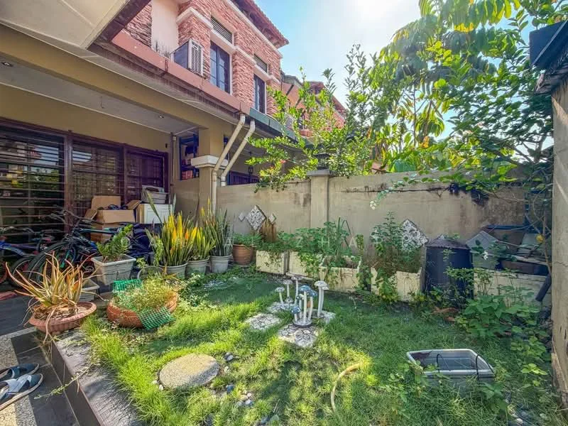 Exterior type: detached bungalow; features: manicured lawn, garden with various plants, stone-paved pathway, fenced garden area, decorative garden stones, outdoor seating area, potted plants, sunlight filtering through trees; style: modern.