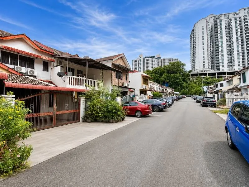 Exterior type: linked terrace house; features: two-storey linked terrace houses, red tiled roofs, white painted facades, air conditioning units visible on walls, driveway with interlocking pavers, manicured shrubs and plants, multiple parked cars, surrounding greenery, urban residential street, adjacent high-rise buildings; style: modern.